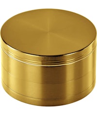 a gold metal grinder on a white background