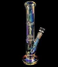 a rainbow colored glass pipe on a black background